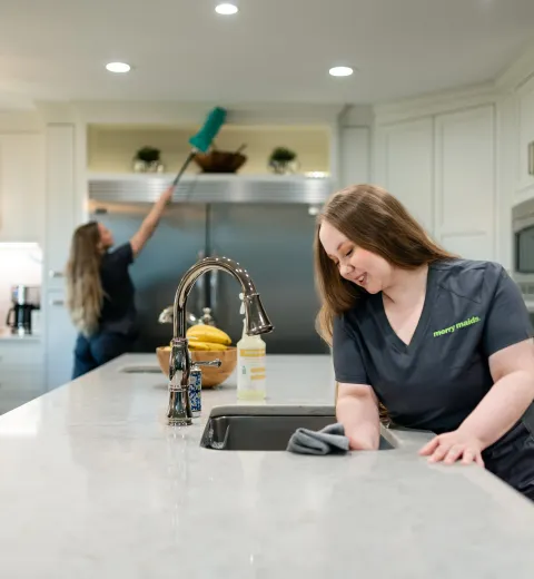 Two Team Members Cleaning Kitchen